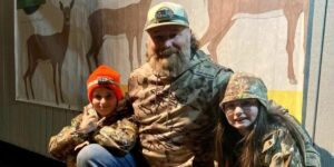 A photo of Joey Dalessio and his children who provided deer donations to those in need in their community.