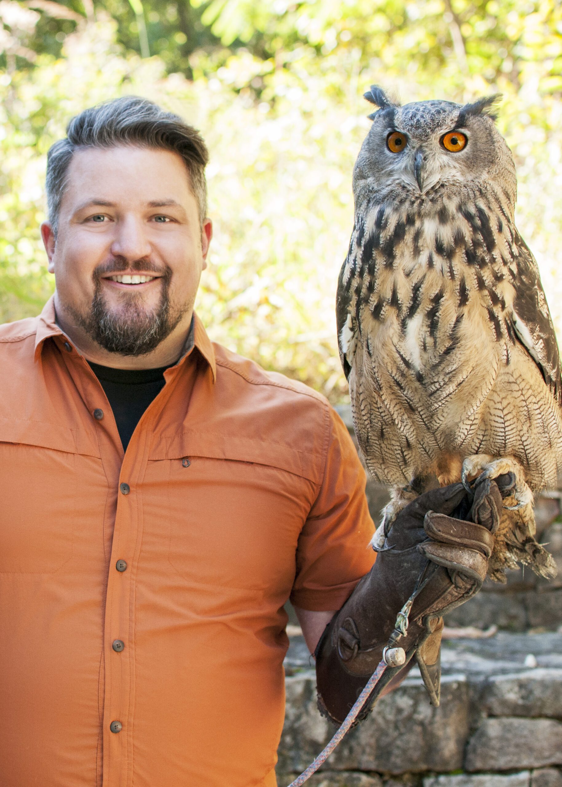 NWF naturalist David Mizejewski with an an owl perched on his arm.