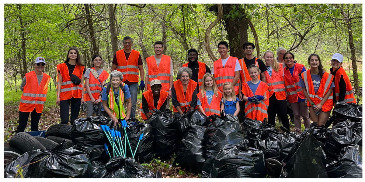 A group of NCWF and MST volunteers posing with numerous bags of trash and pickers.