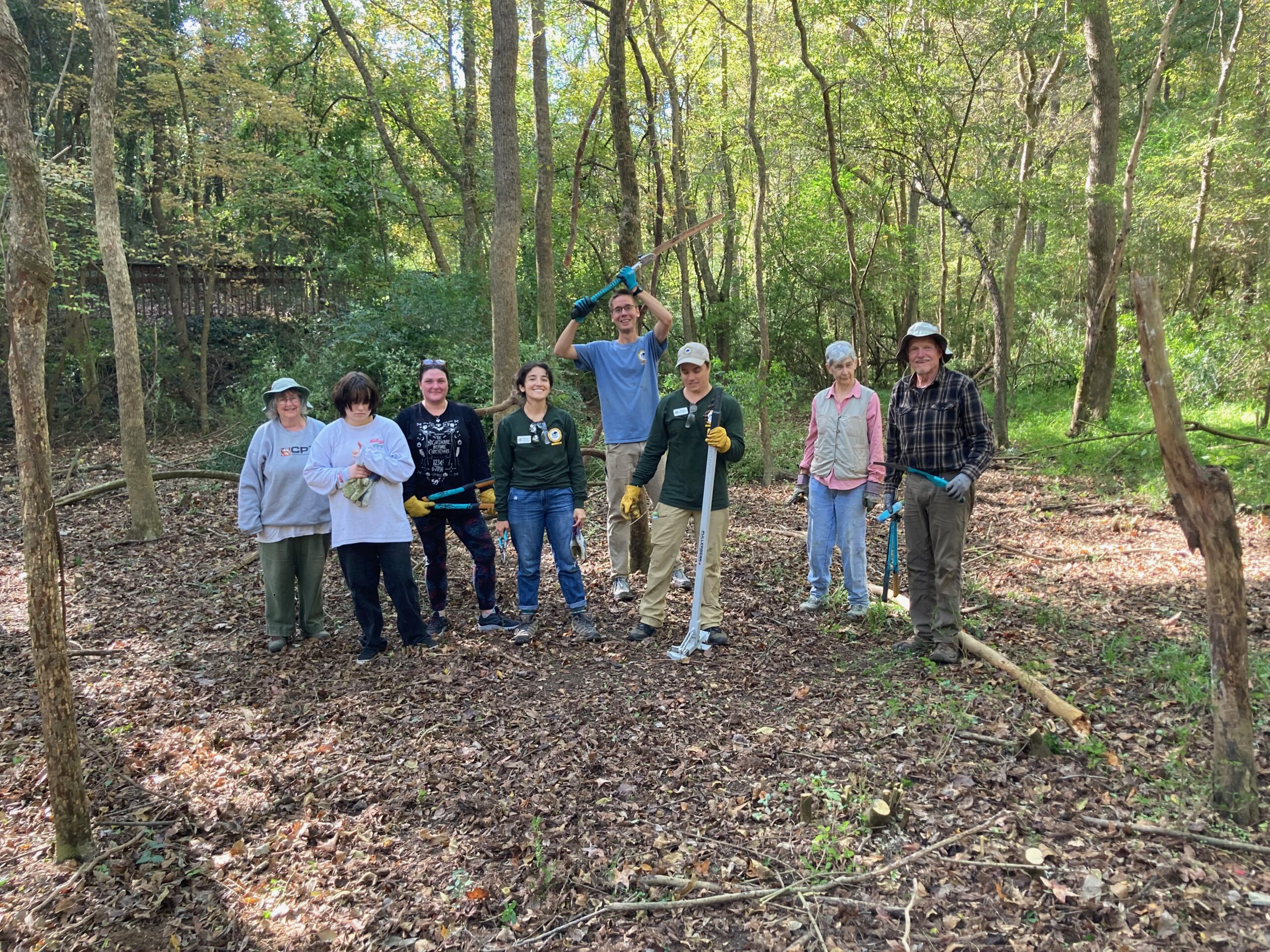 A group of volunteers posing at a Bolin Creek invasive plant removal workday.