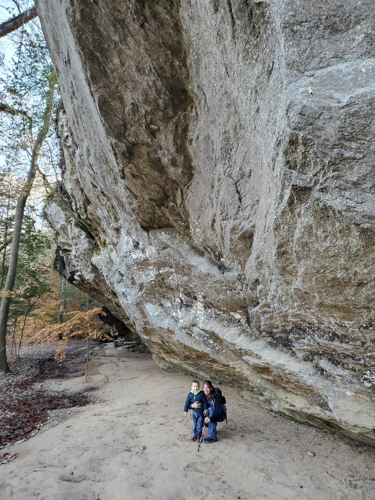 A woman and boy stand by a massive geologic feature at Raven Rock Park.