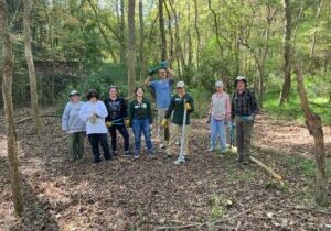 A group of volunteers posing at a Bolin Creek invasive plant removal workday.