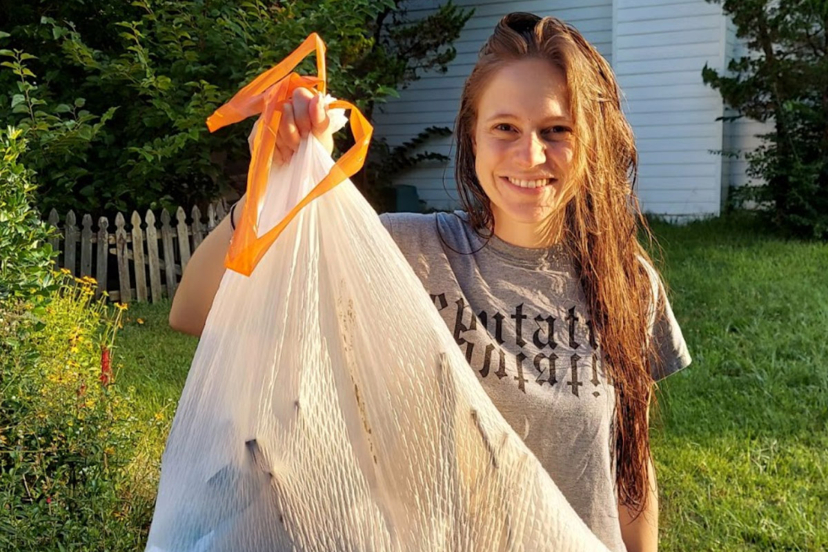 Community Activist holding up a bag of collected trash